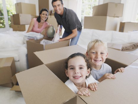 Professional movers loading a van with household items