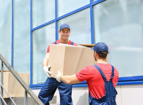 Professional movers packing household items