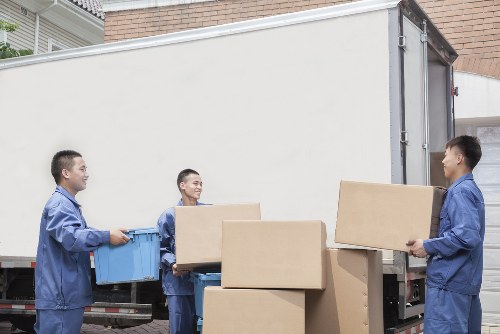 Professional packers securing office equipment